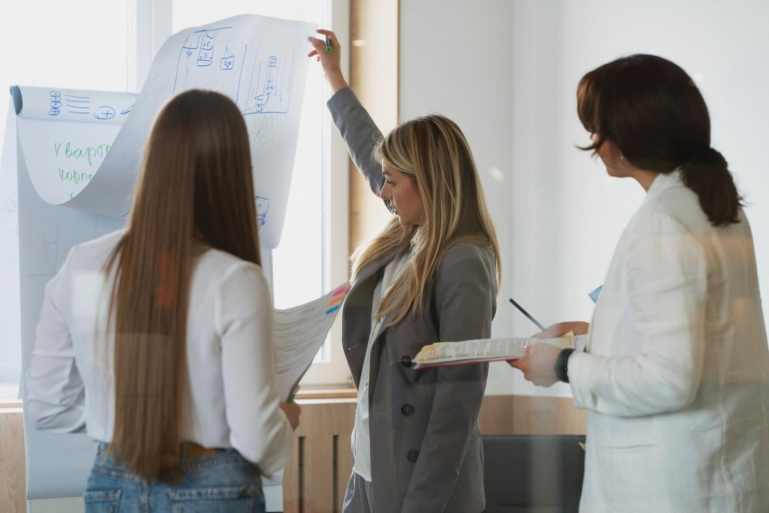 UX design students collaborating on user interface mockups and wireframes